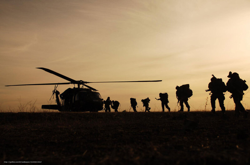 Soldiers silhouetted at sunset