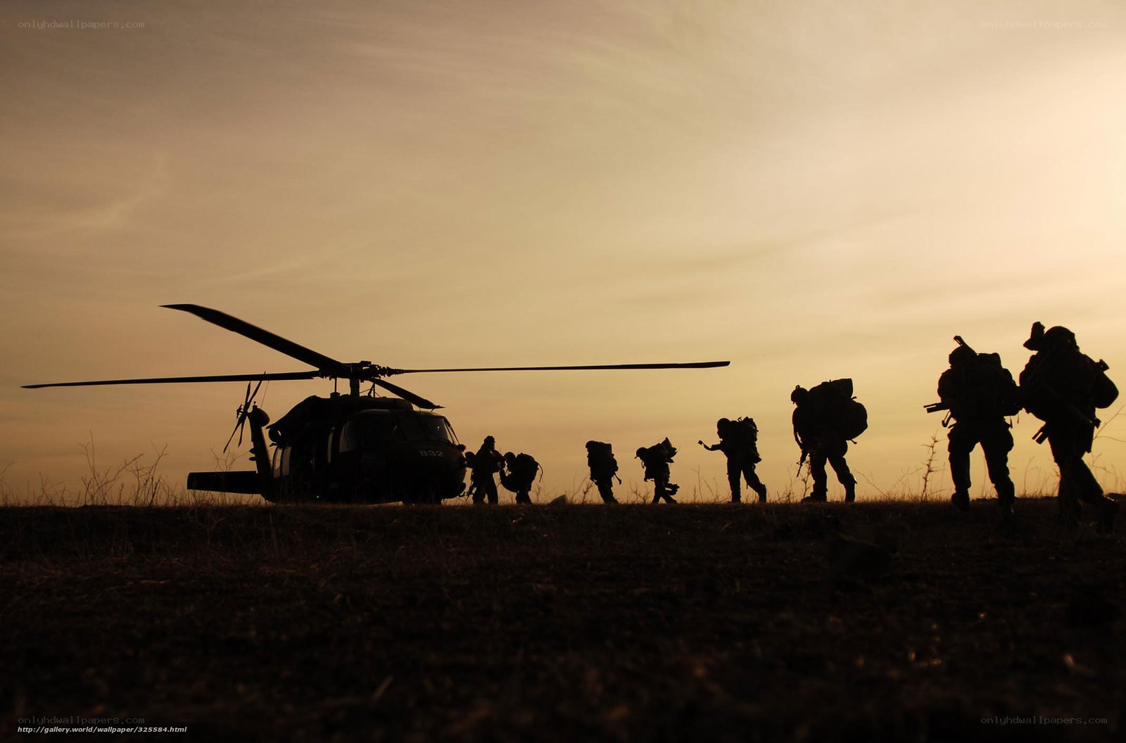 Soldiers silhouetted at sunset