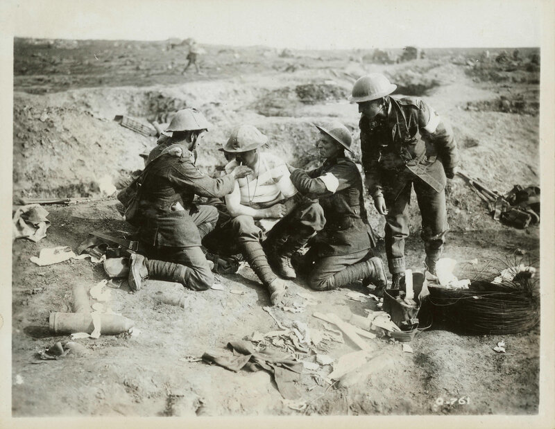 Soldiers treating wounded comrade