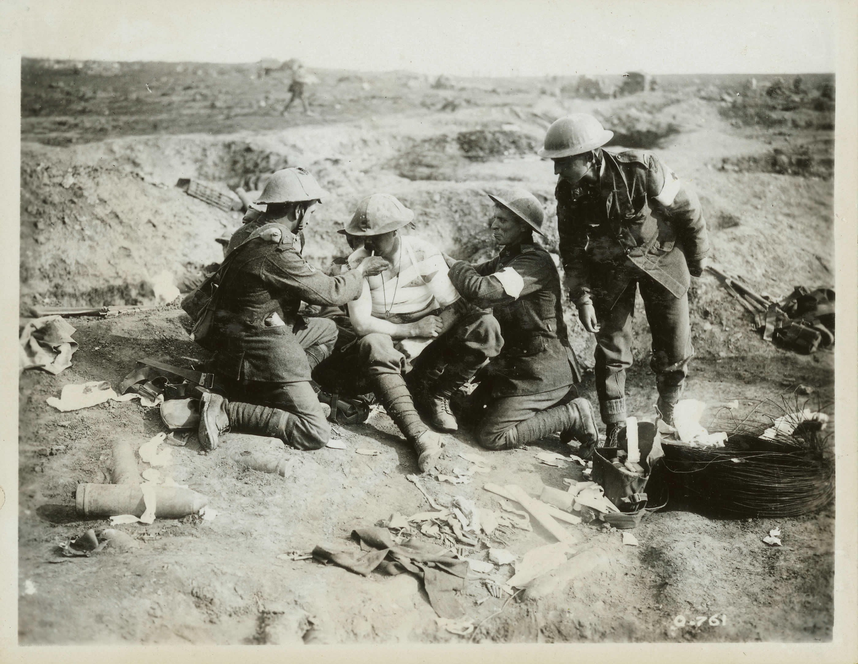 Soldiers treating wounded comrade
