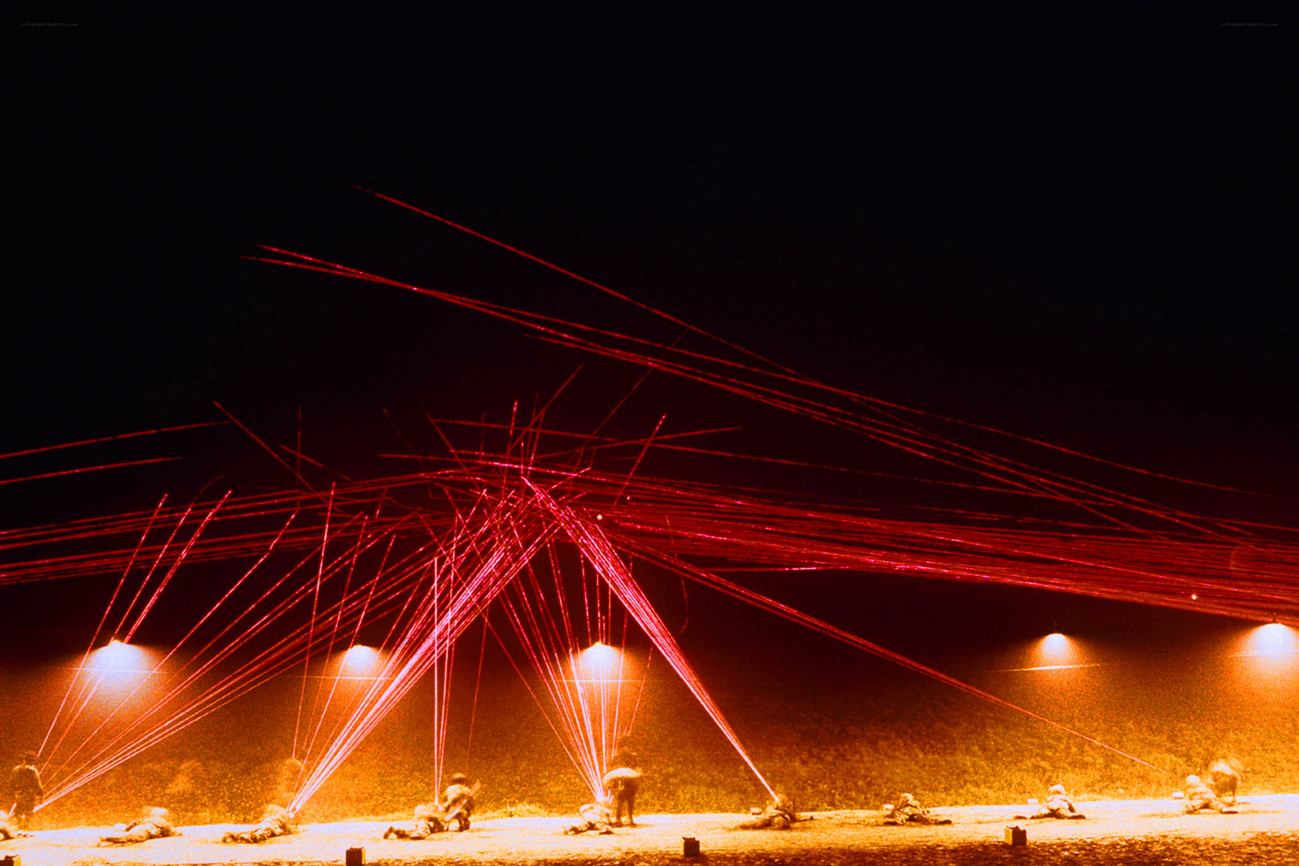 Soldiers under red laser beams