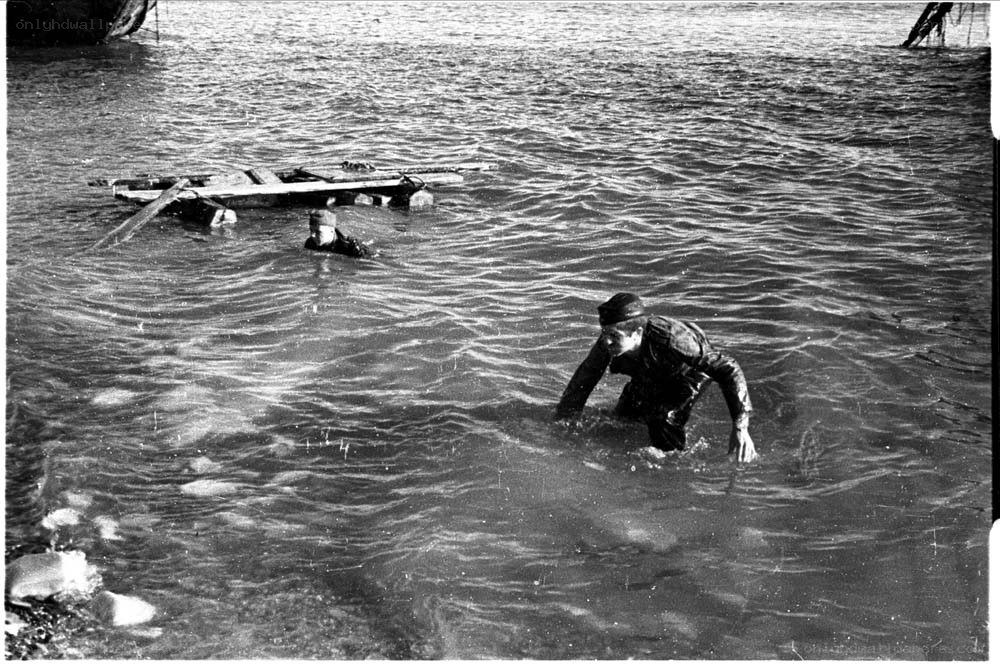 Soldiers wading through water