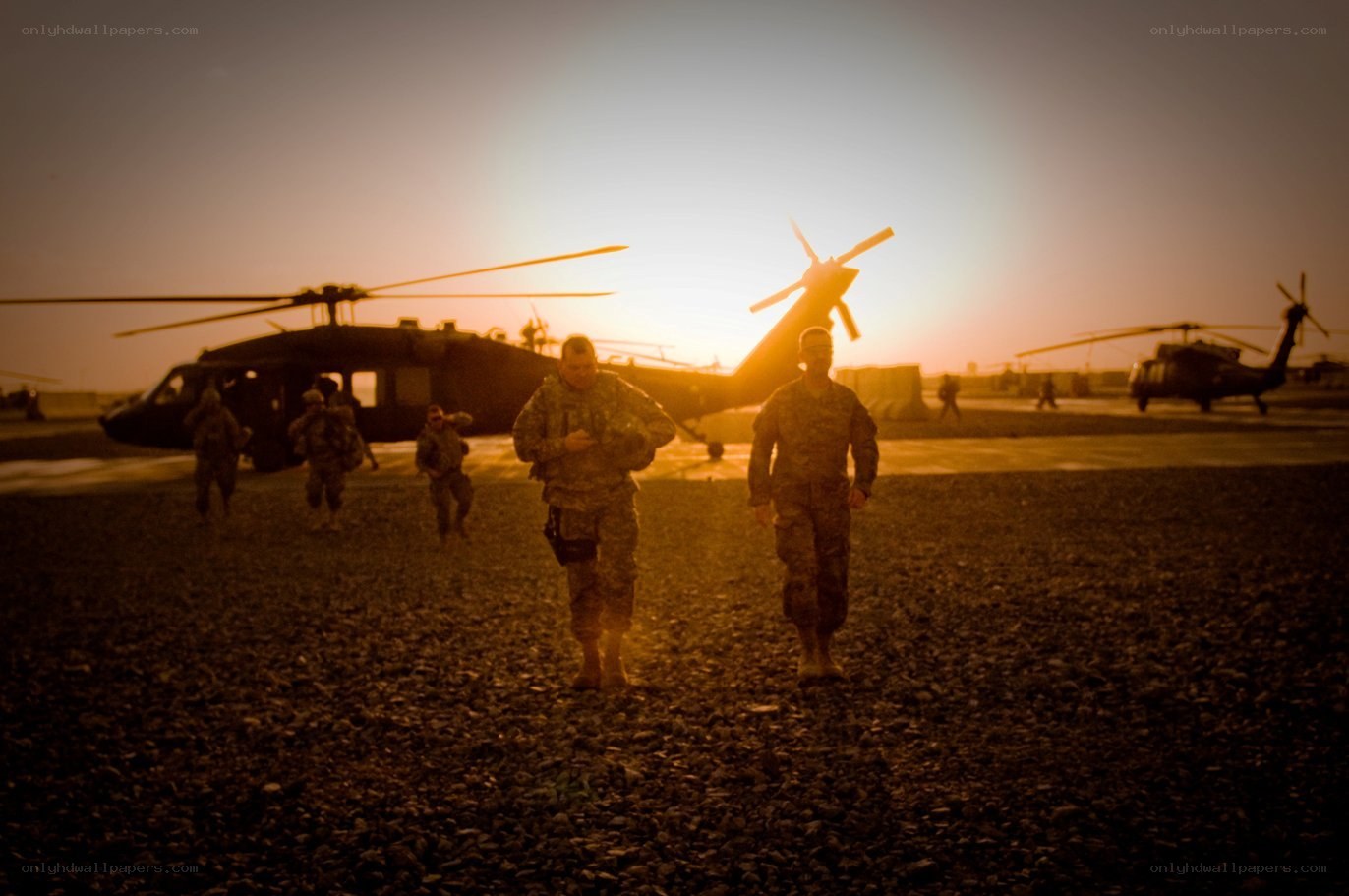 Soldiers walking at sunset