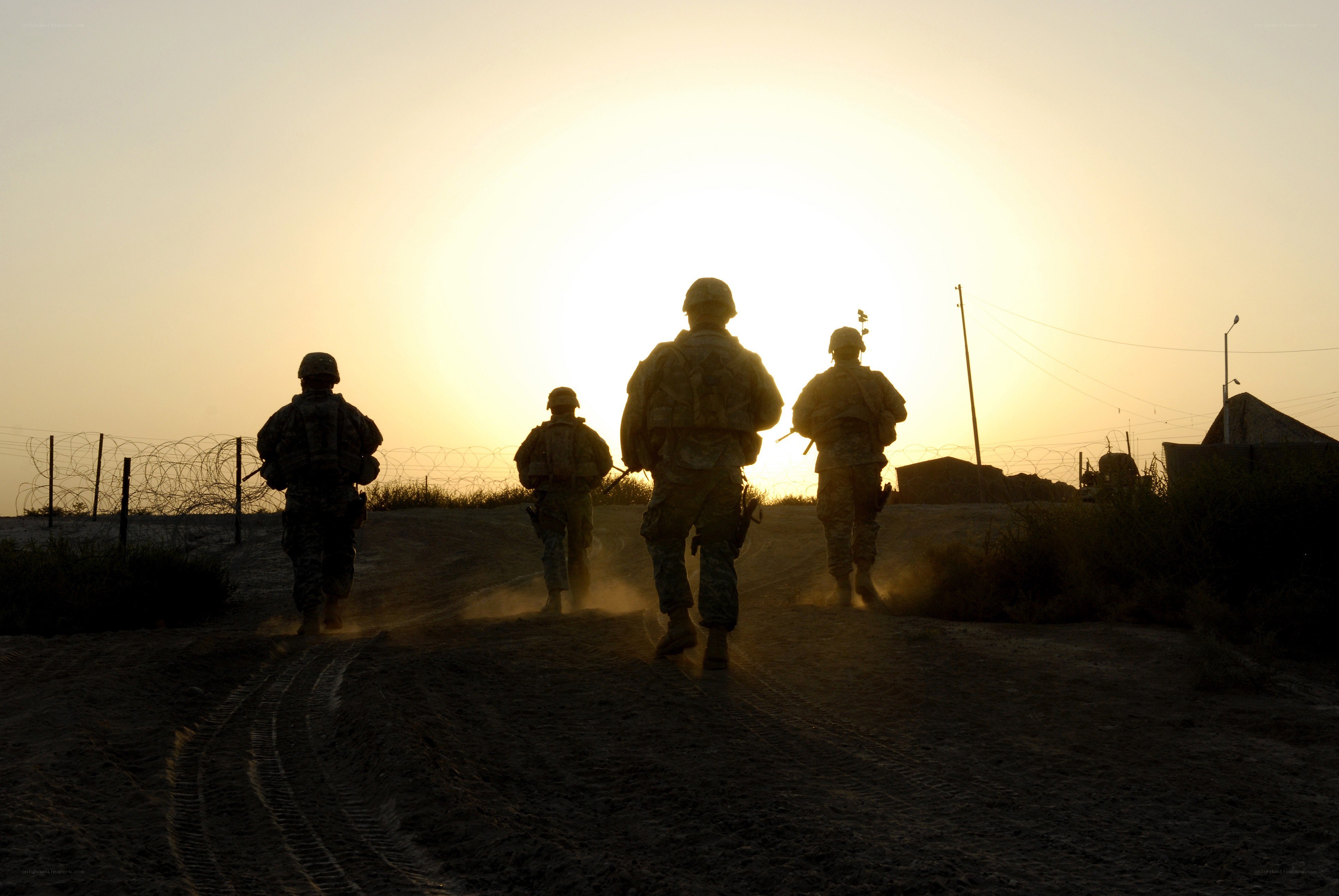 Soldiers walking at sunset