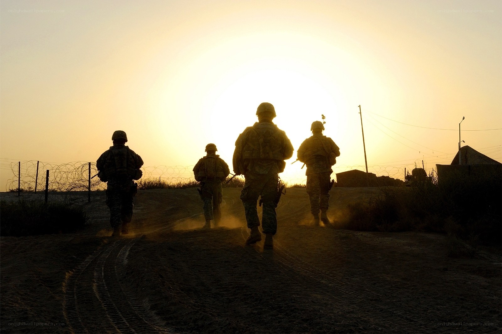 Soldiers walking at sunset
