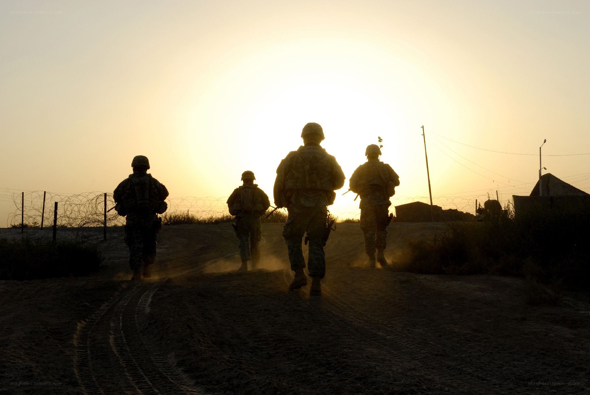 Soldiers walking at sunset