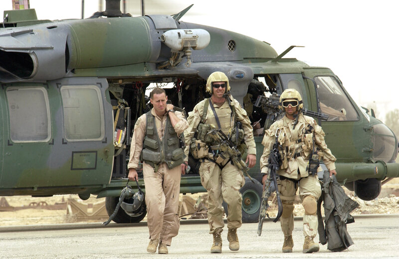 Soldiers walking near helicopter