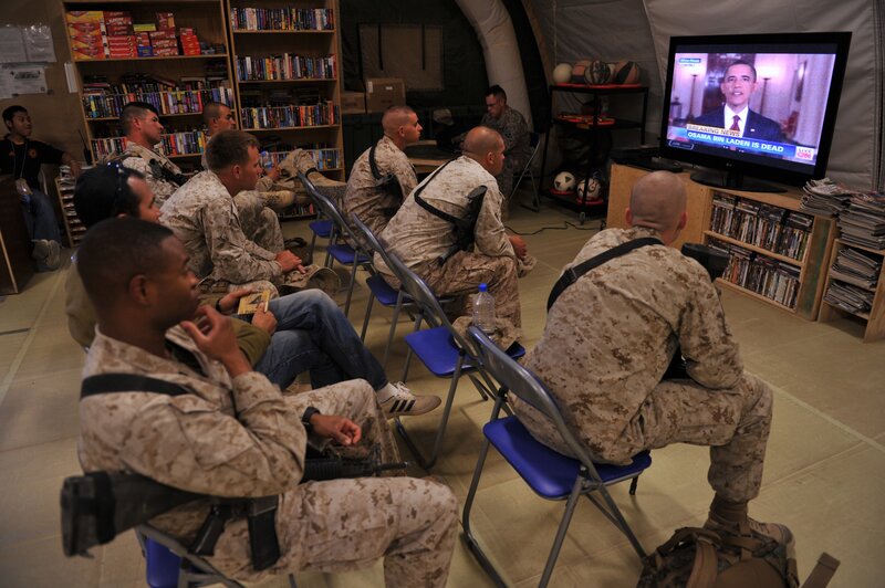 Soldiers watching news on TV