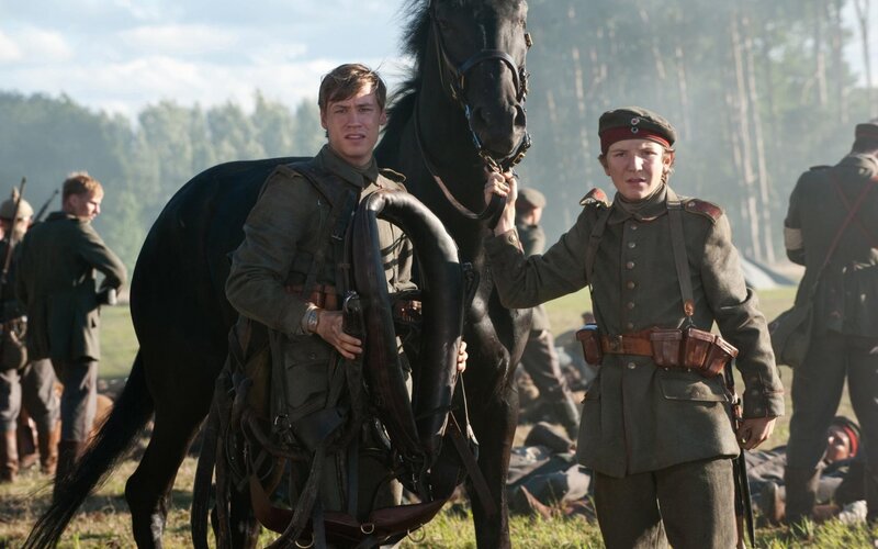 Soldiers with a horse in a field