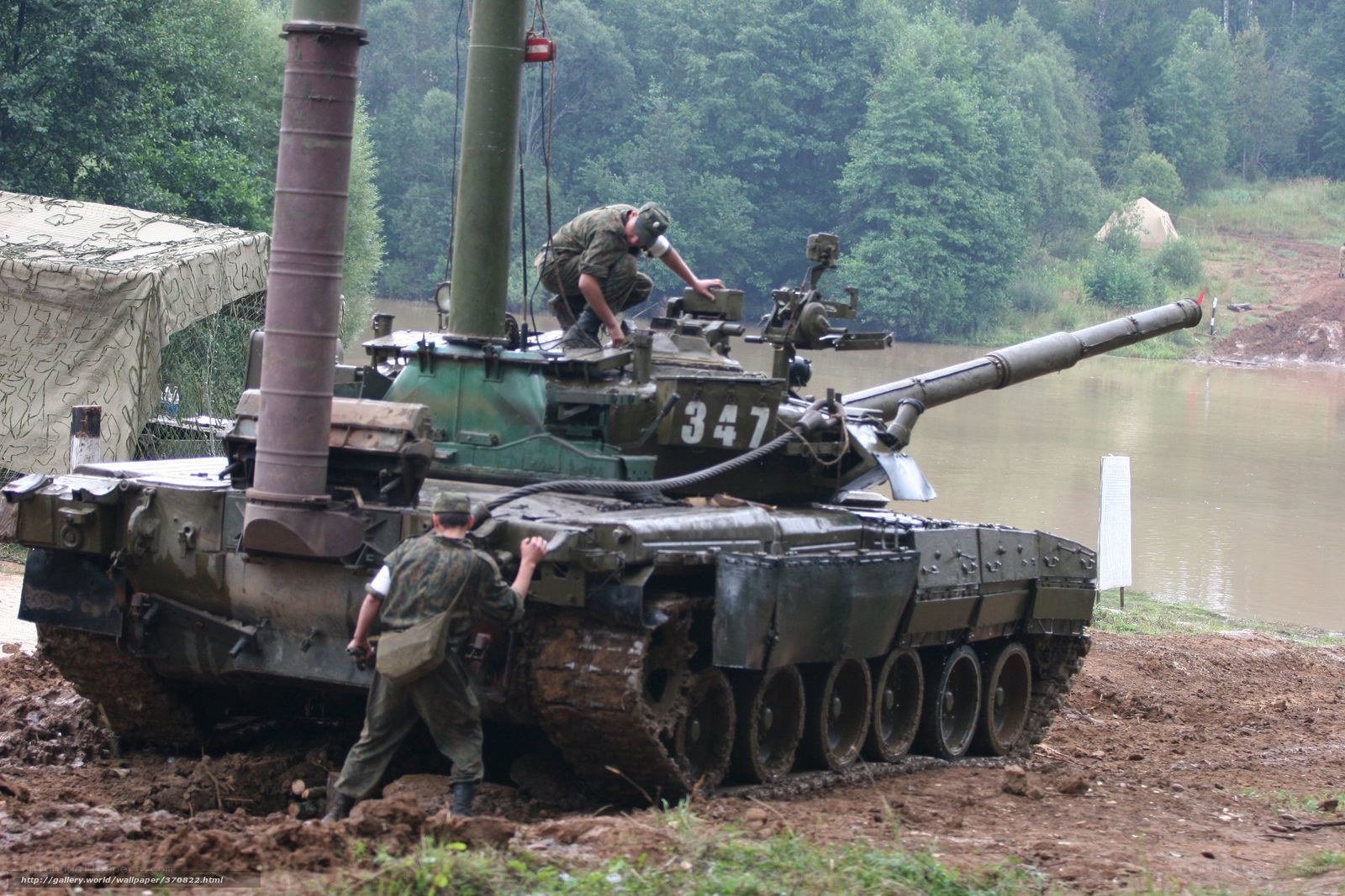 Soldiers with a tank in muddy terrain