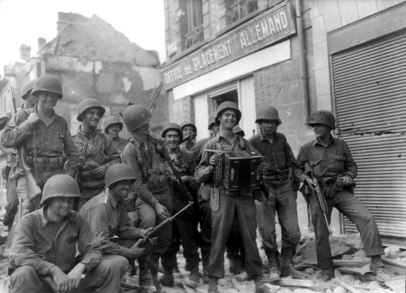 Soldiers with accordion in war-torn town