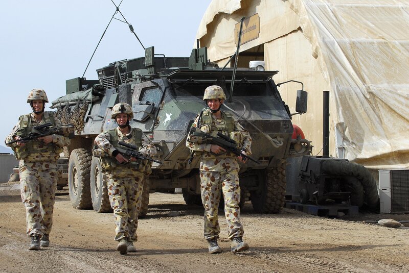 Soldiers with armored vehicle