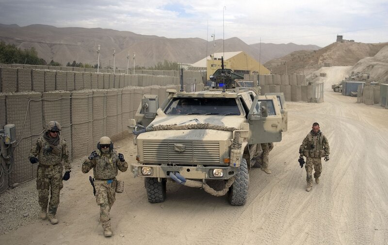 Soldiers with armored vehicle