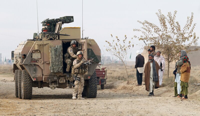 Soldiers with armored vehicle