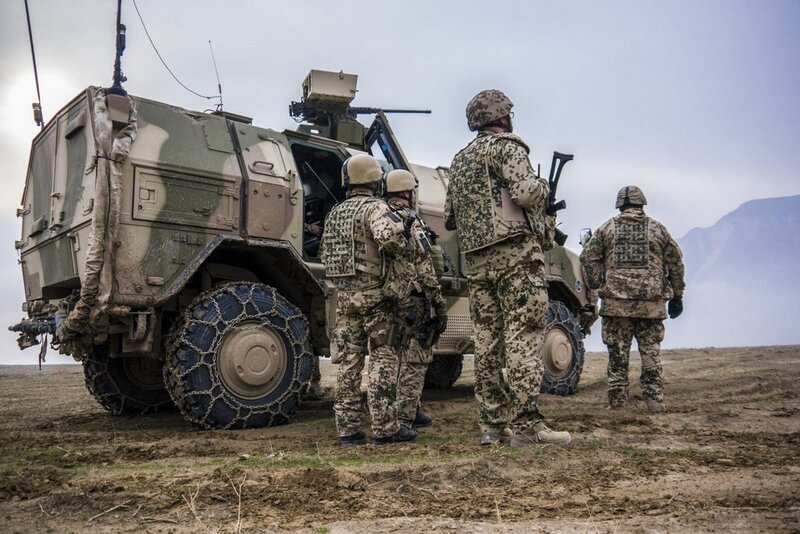 Soldiers with armored vehicle