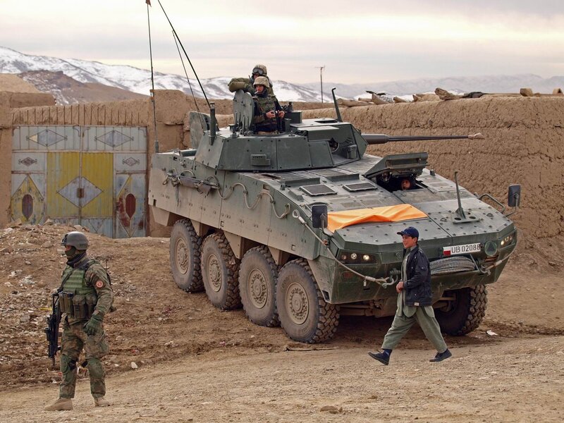Soldiers with armored vehicle