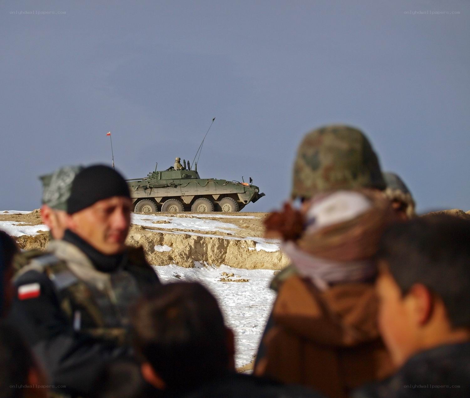 Soldiers with armored vehicle