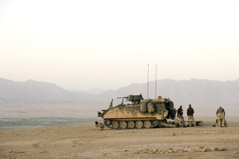 Soldiers with armored vehicle in desert
