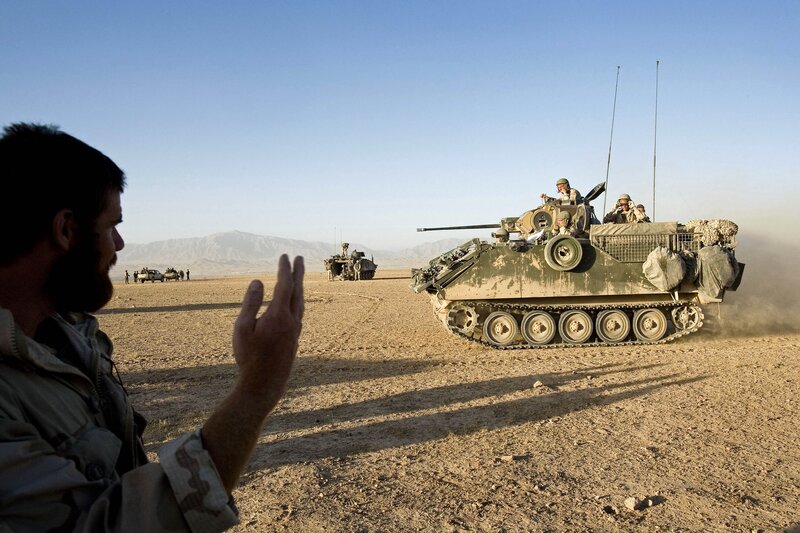 Soldiers with armored vehicle in desert
