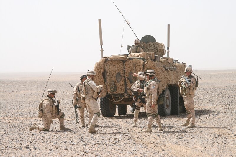Soldiers with armored vehicle in desert