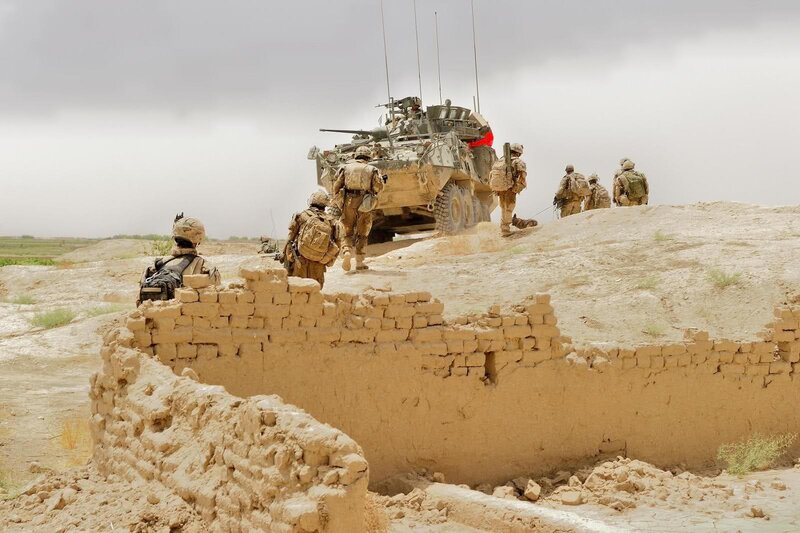 Soldiers with armored vehicle in desert