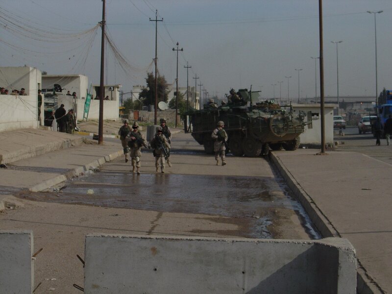 Soldiers with armored vehicle on street