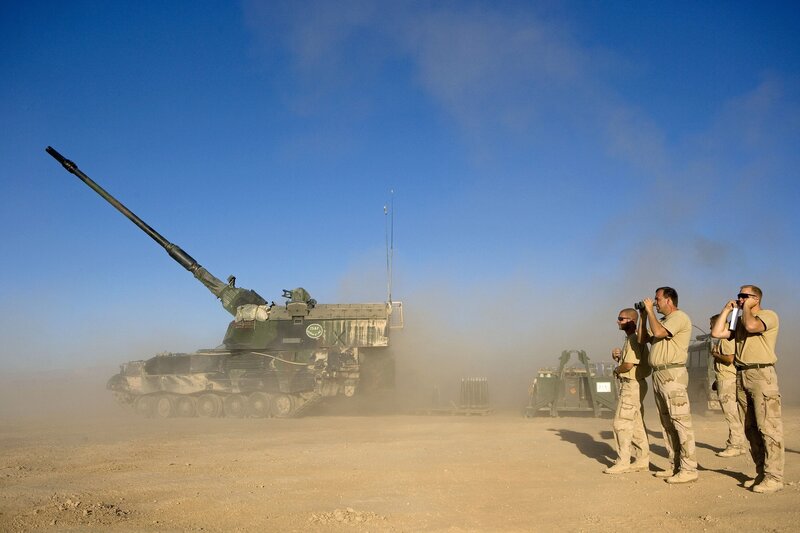 Soldiers with artillery in desert
