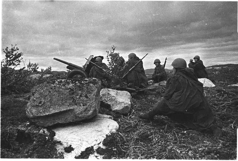 Soldiers with artillery in field