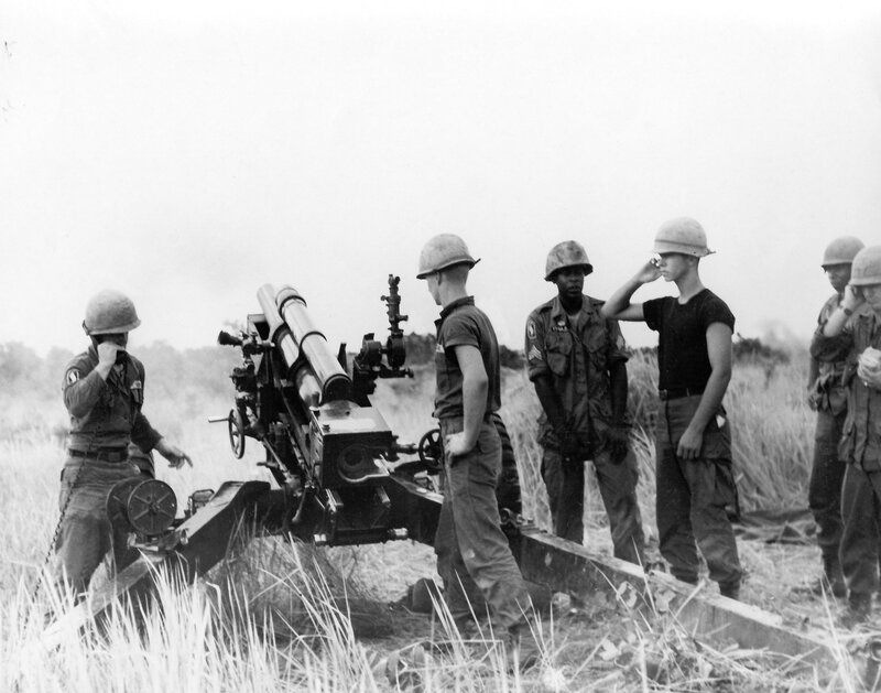 Soldiers with artillery in field