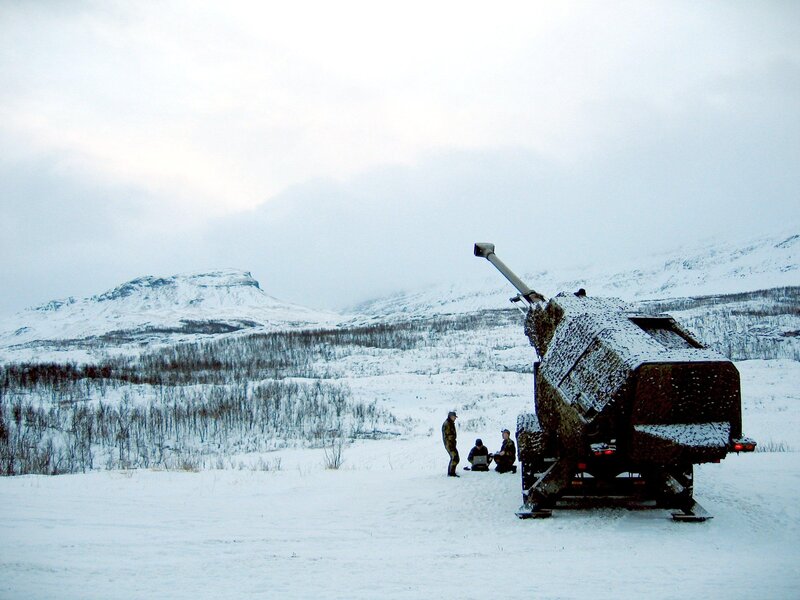 Soldiers with artillery in snowy landscape