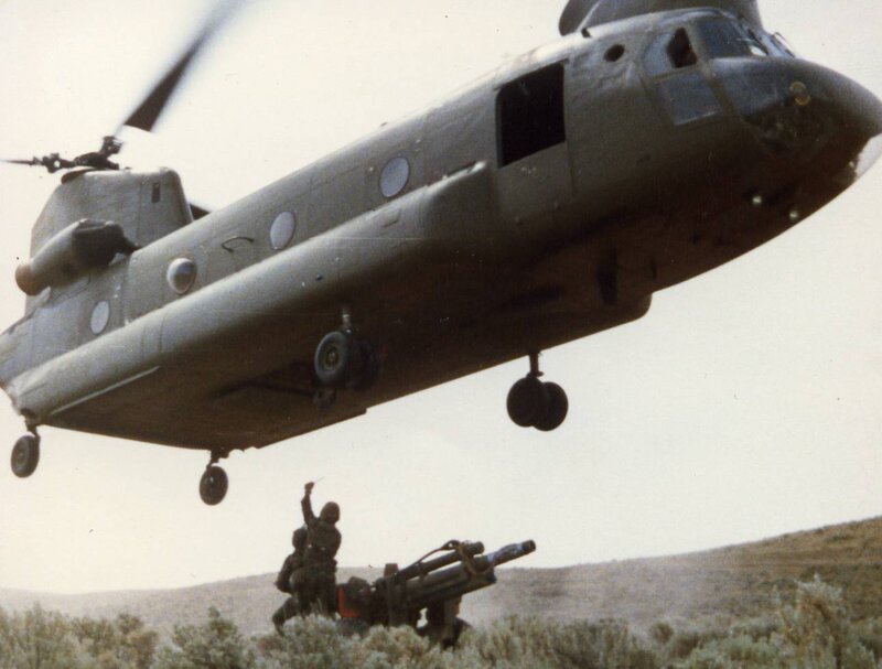 Soldiers with artillery under helicopter
