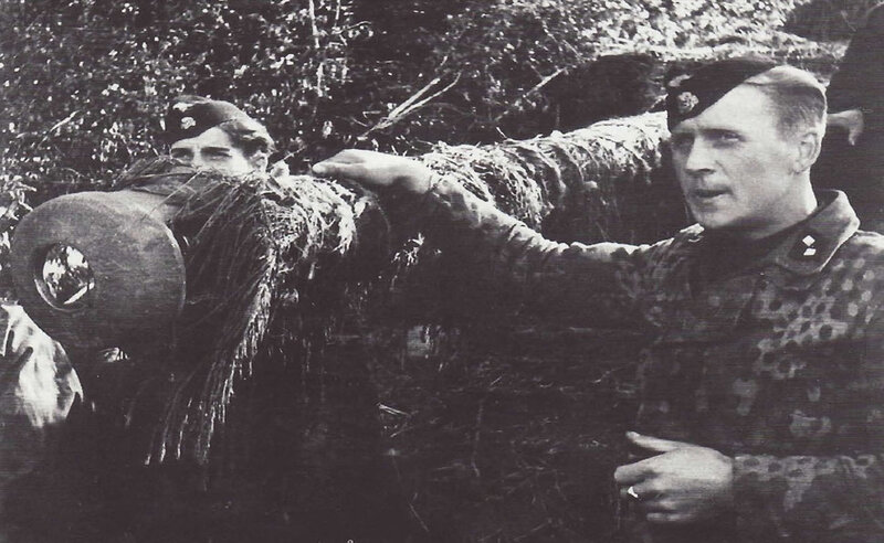 Soldiers with camouflaged artillery