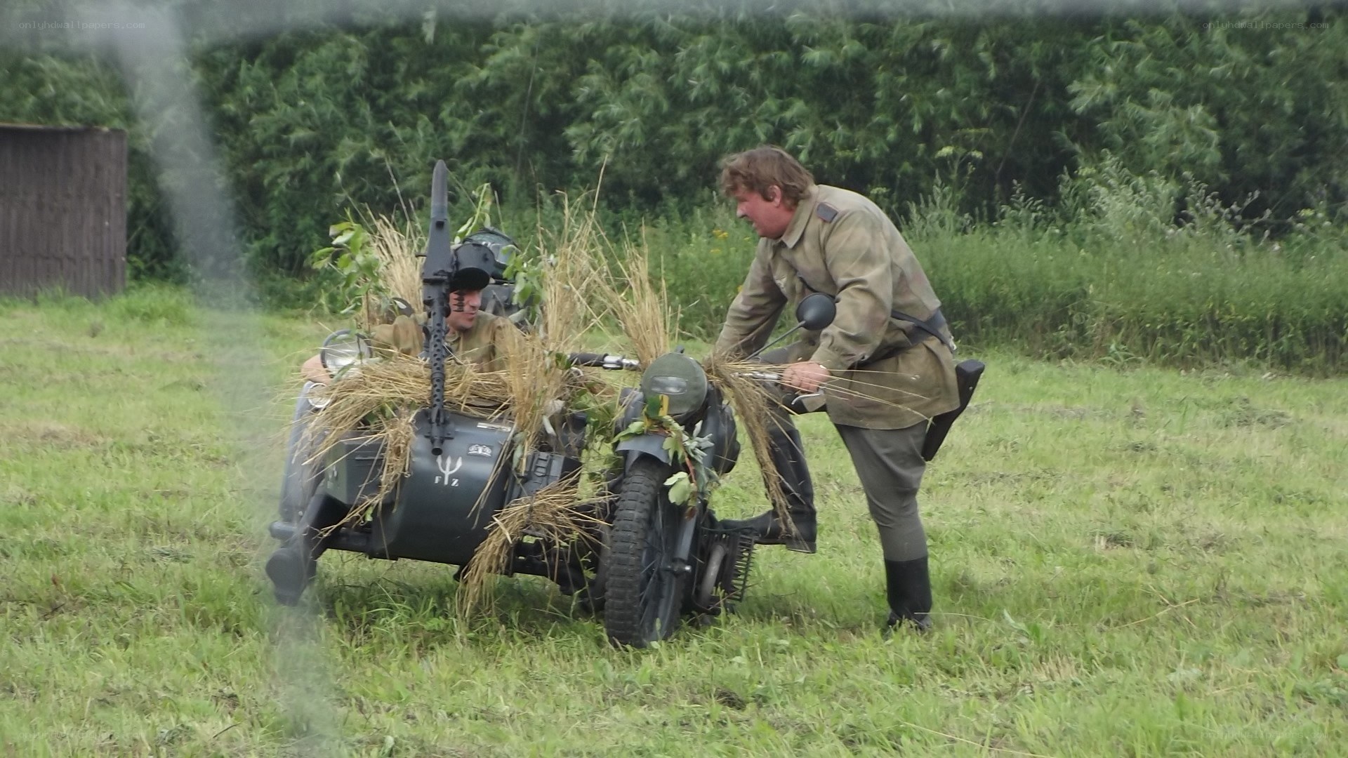 Soldiers with camouflaged motorcycle