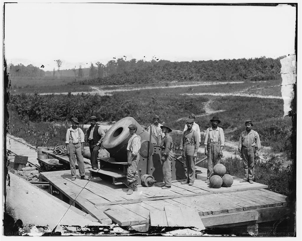Soldiers with cannon on flatcar