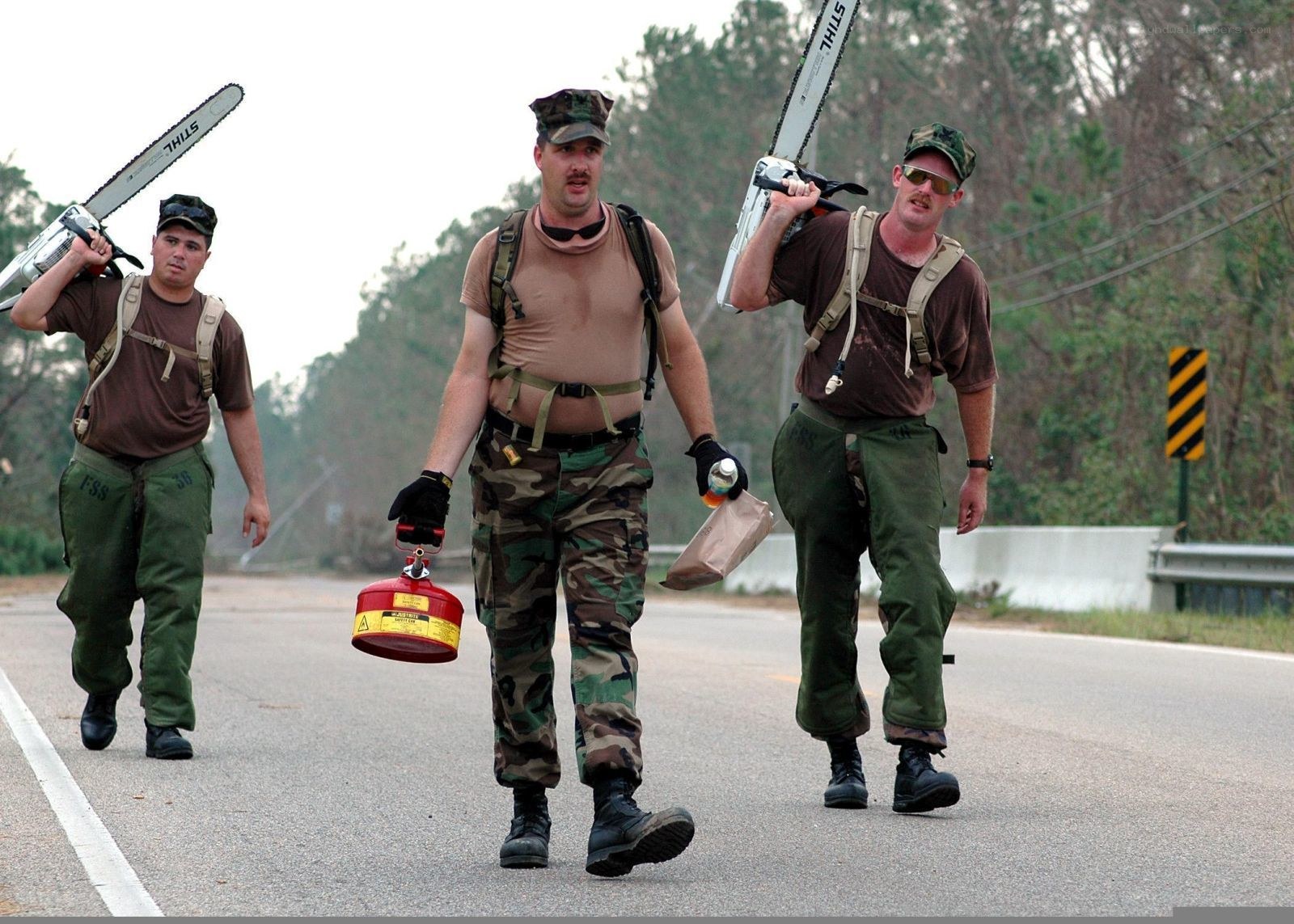Soldiers with chainsaws on road
