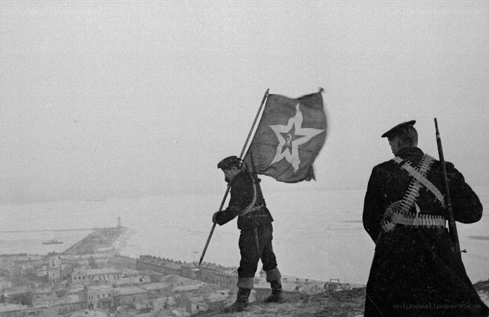 Soldiers with flag on hill