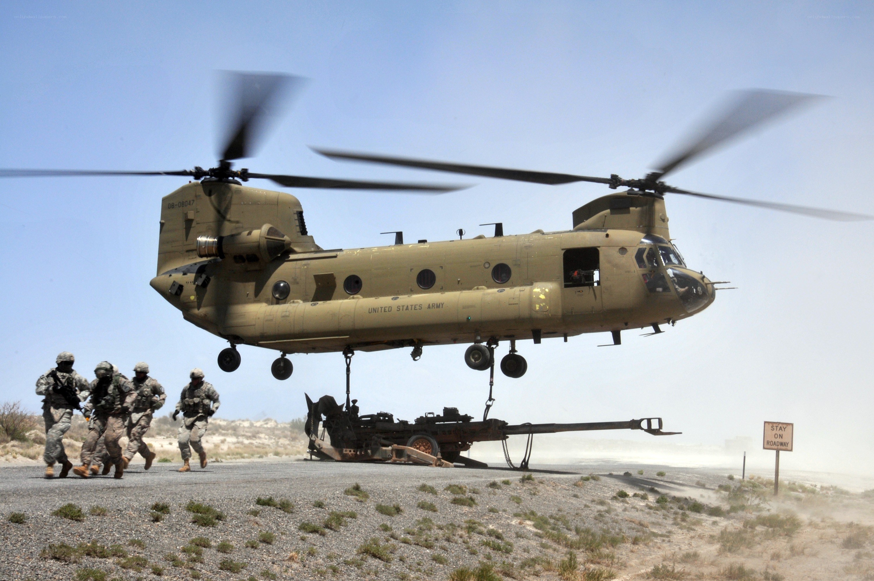 Soldiers with helicopter and artillery