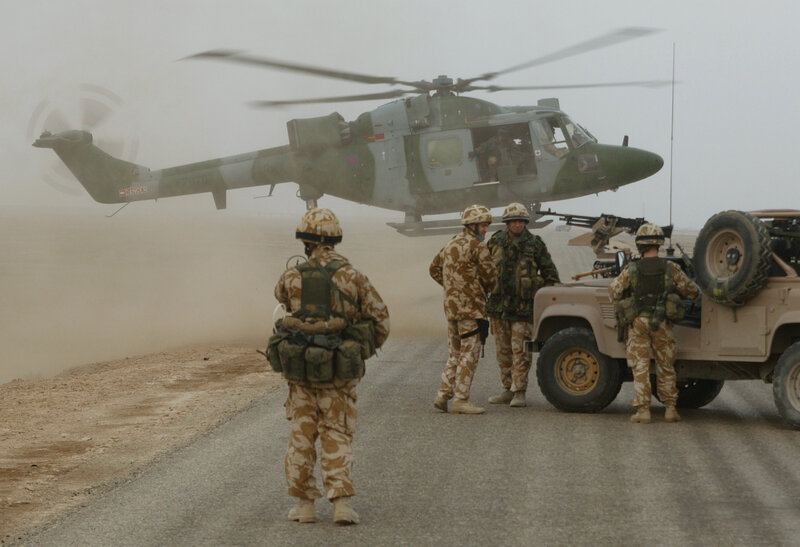 Soldiers with helicopter and vehicle