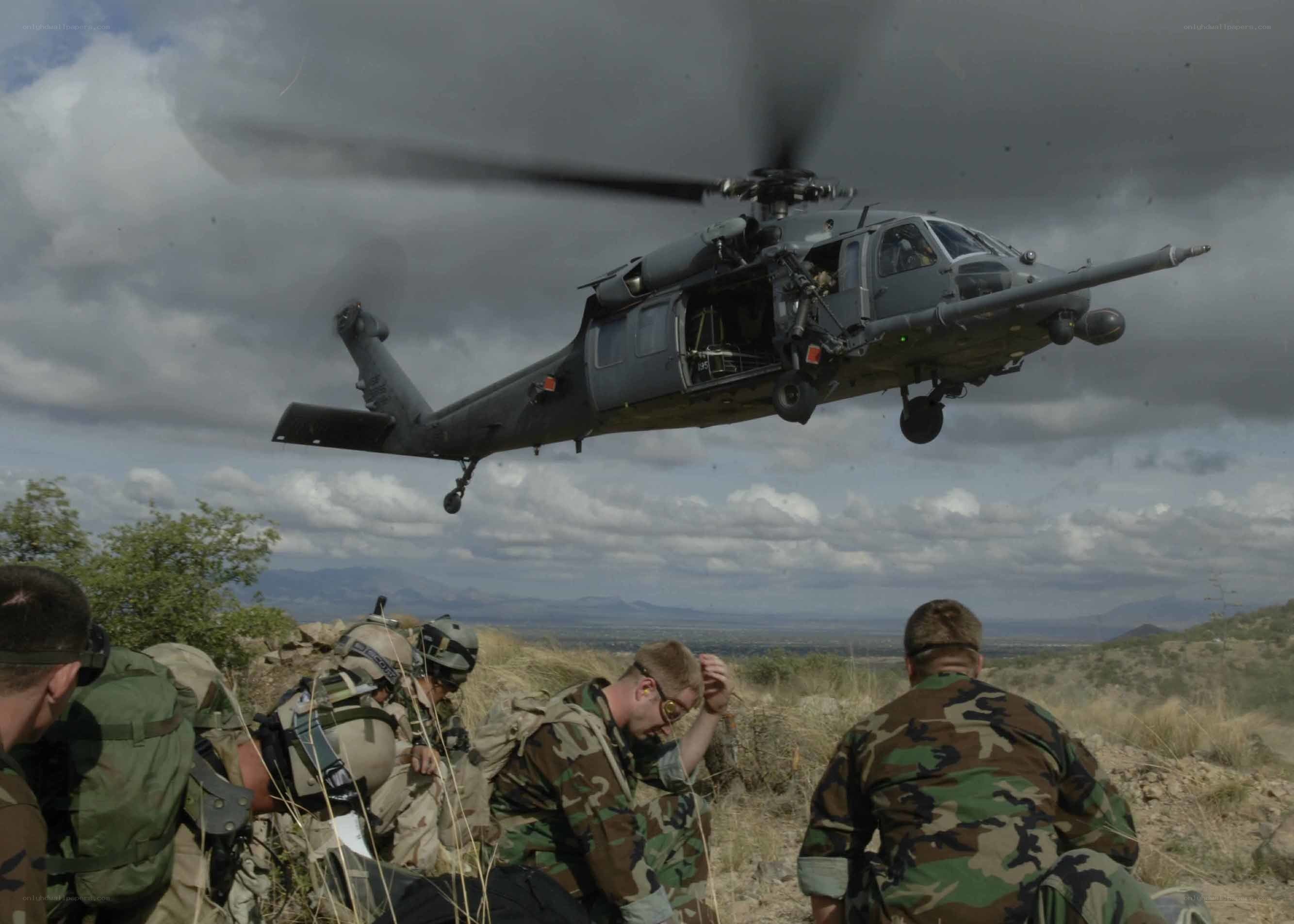 Soldiers with helicopter in desert