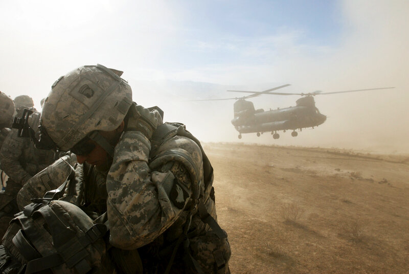 Soldiers with helicopter in desert