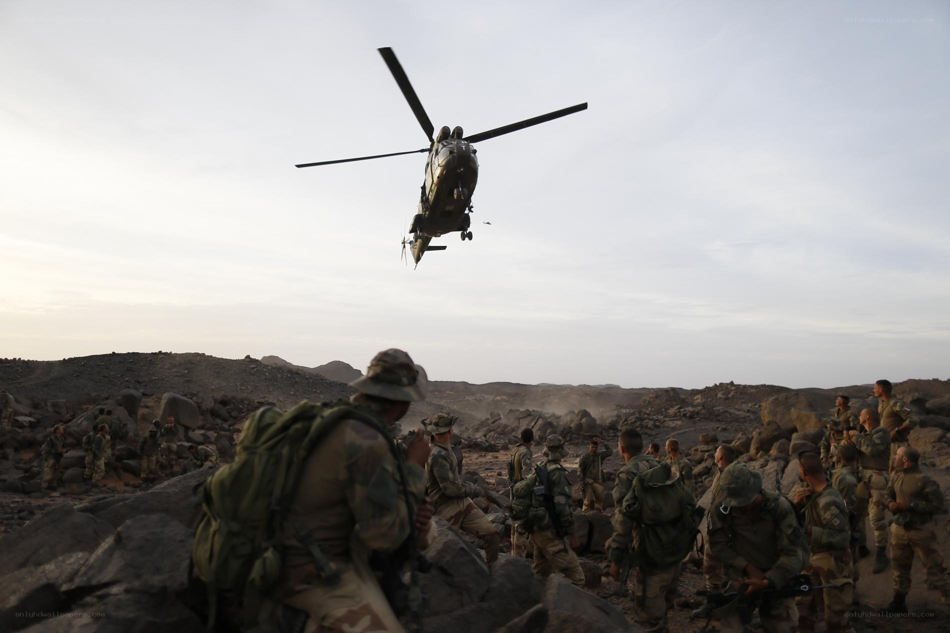 Soldiers with helicopter in desert