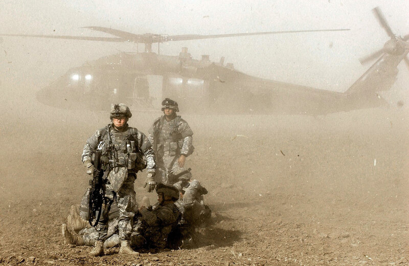 Soldiers with helicopter in dust storm