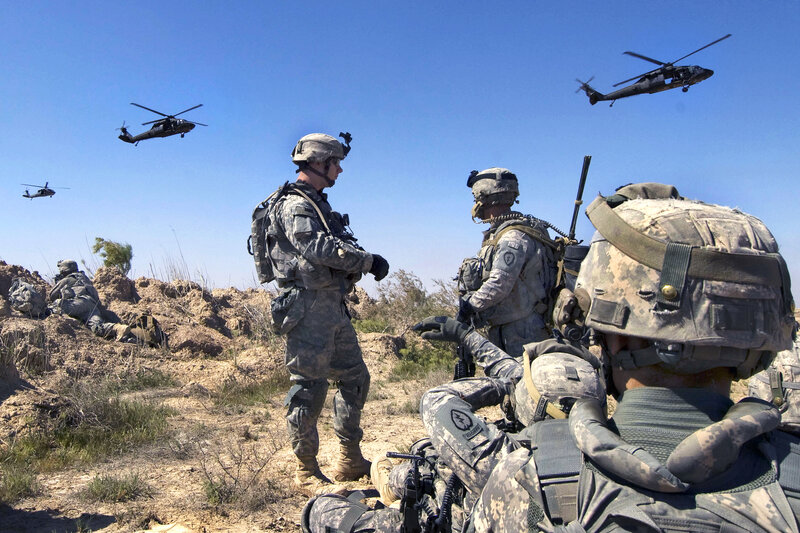 Soldiers with helicopters in desert