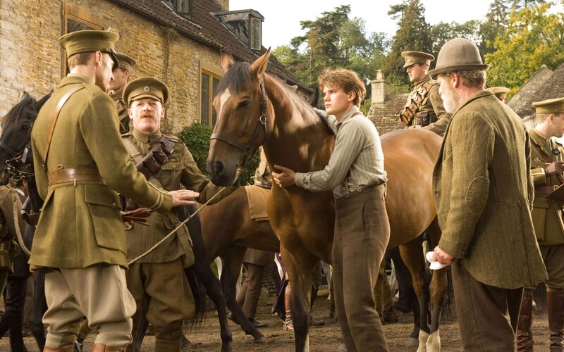 Soldiers with horses in village