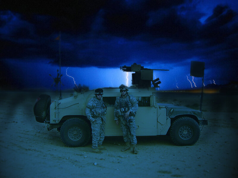 Soldiers with Humvee in storm