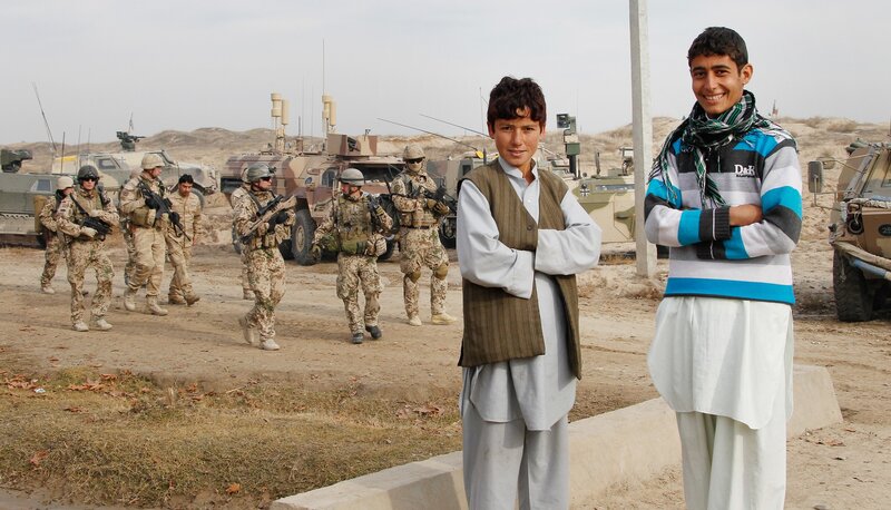 Soldiers with local boys in Afghanistan