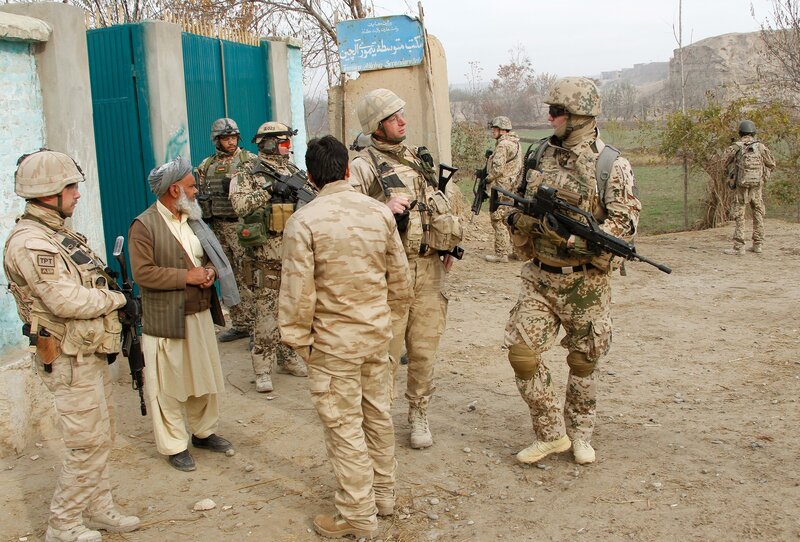 Soldiers with local men at checkpoint