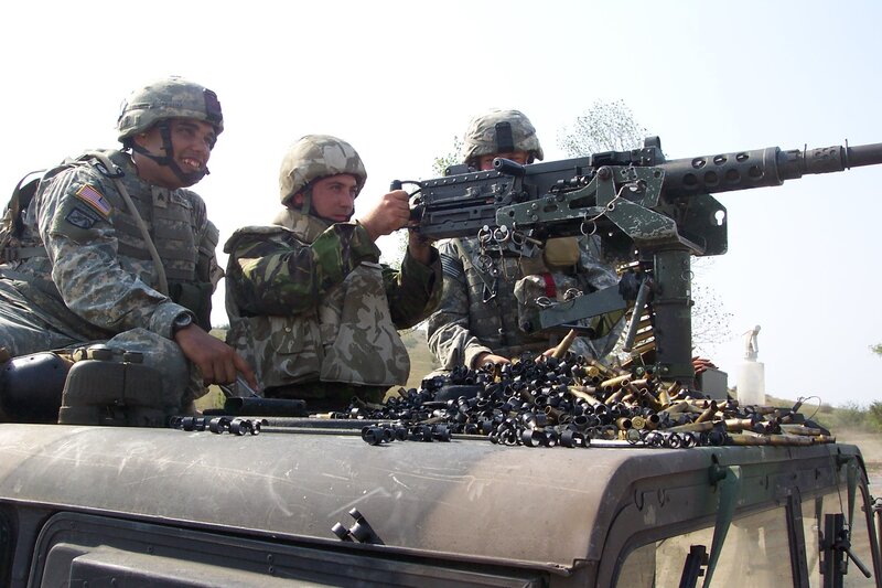 Soldiers with machine gun on vehicle