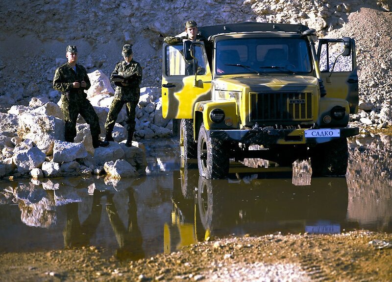 Soldiers with military truck in water