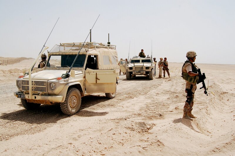 Soldiers with military vehicles in desert